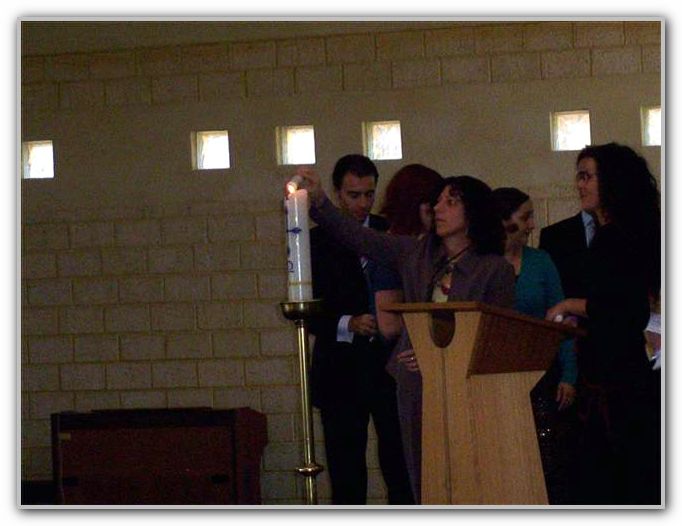 Jo lighting a candle at TK Baptism